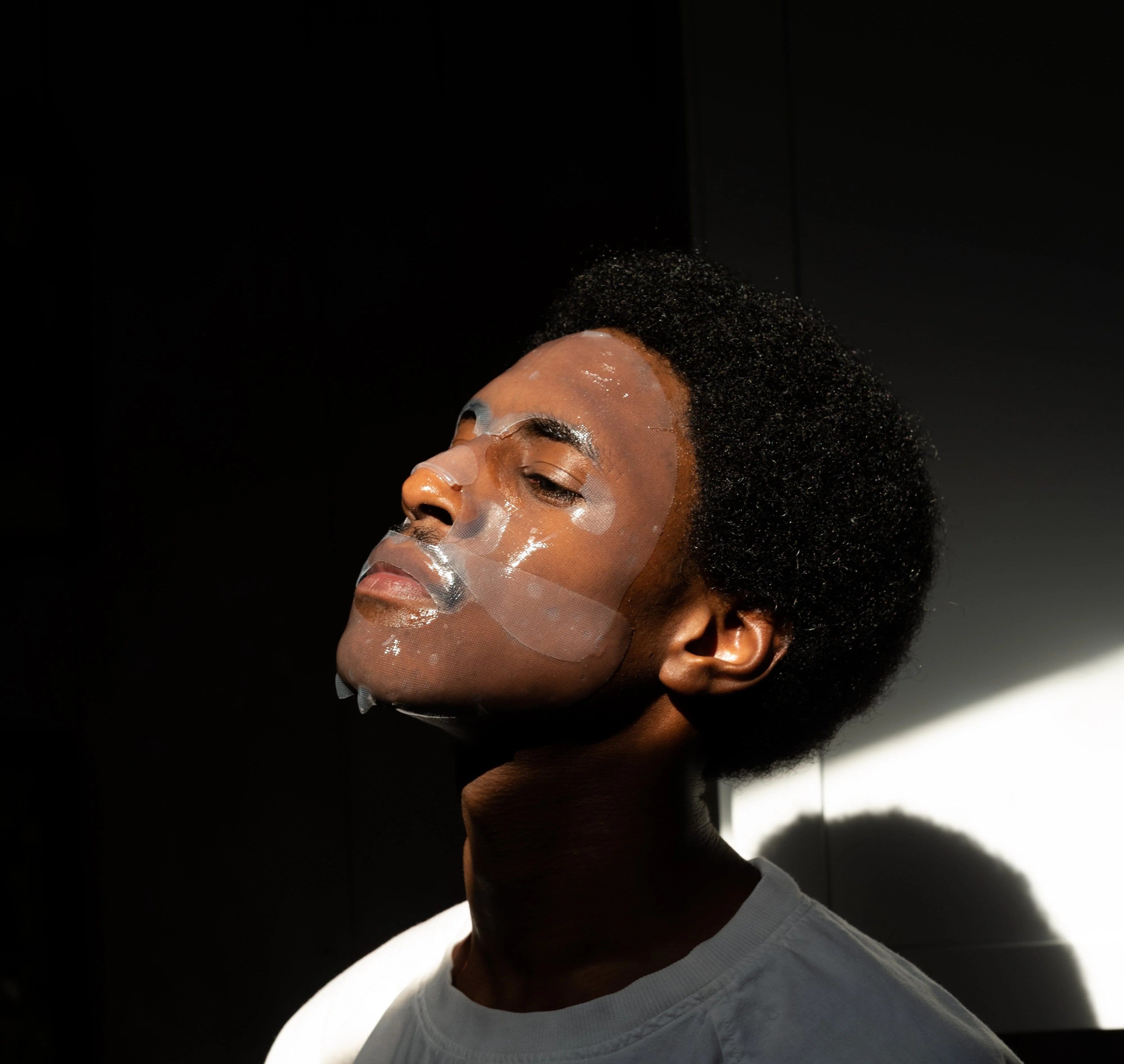 Man using a facial sheet mask for skincare