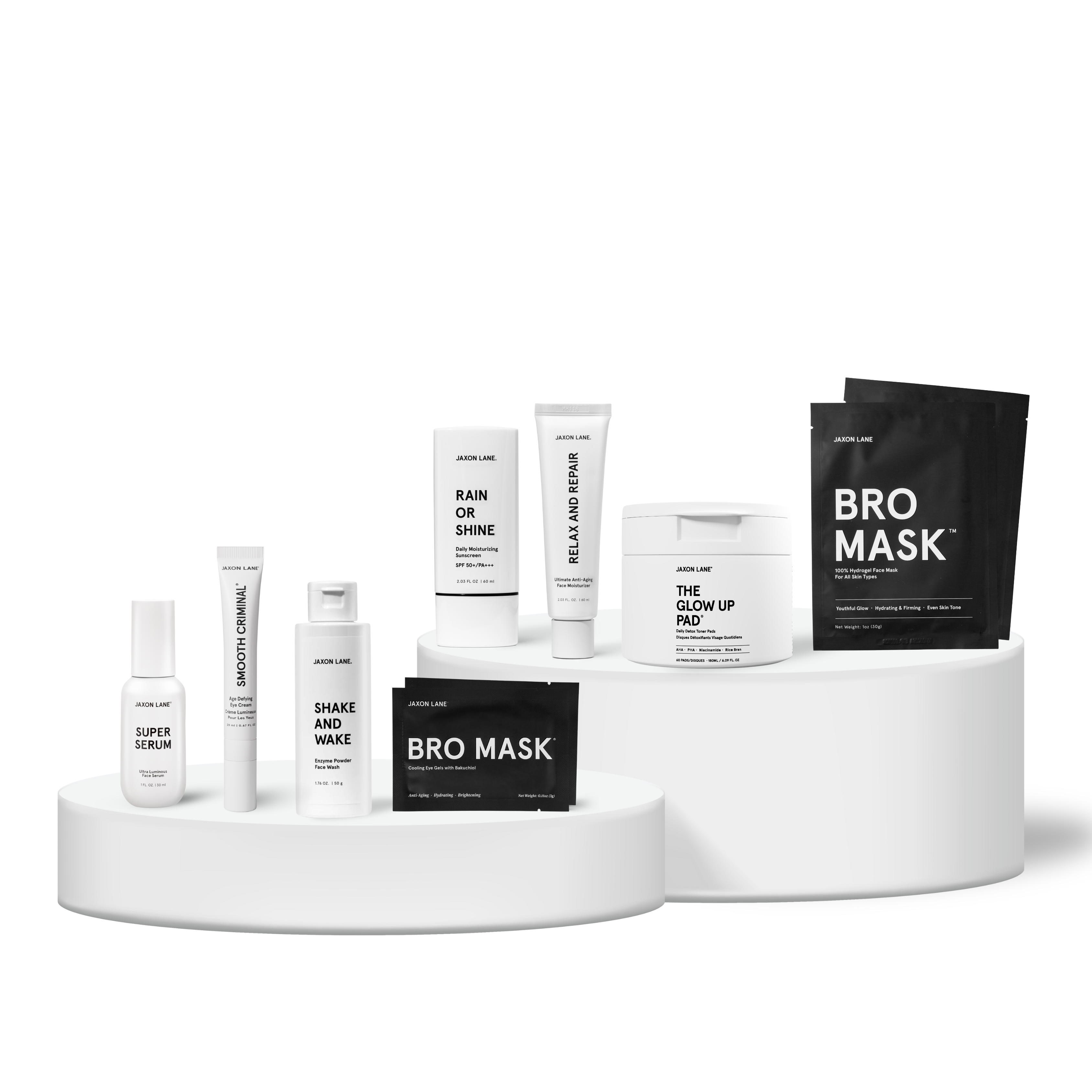 Collection of jaxon lane skincare products on a white platform with a white background
