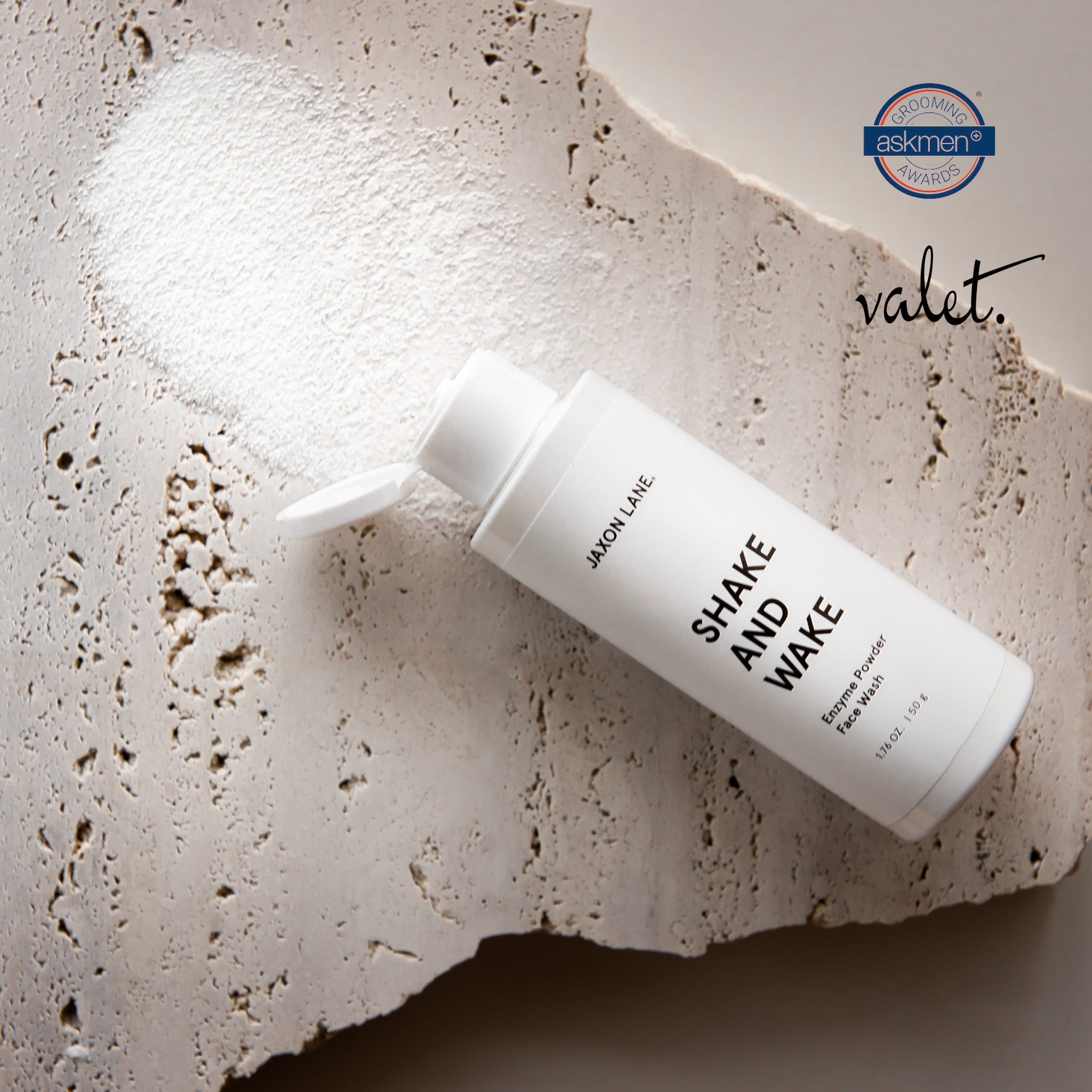 Skincare bottle labeled 'Shake and Wake' by JAXON LANE on a textured surface with 'valet' branding.