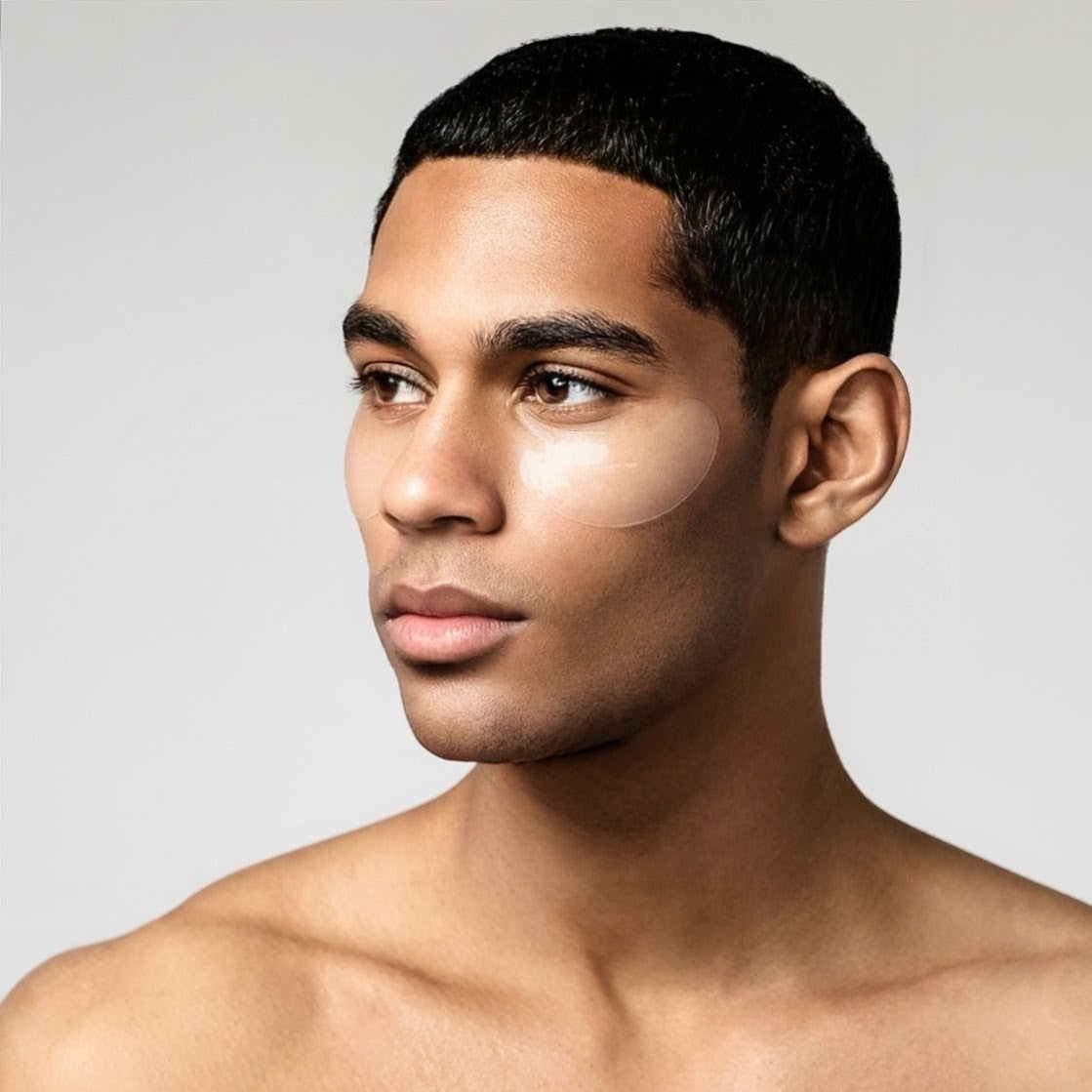 Man with a neutral expression on a plain background wearing bro mask eye gels