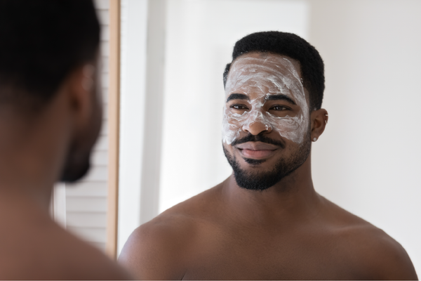 Man using a Facial Scrub, Staring at himself in the mirror