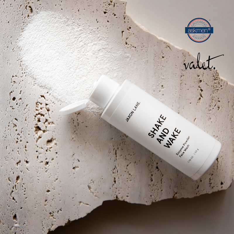 Skincare bottle labeled 'Shake and Wake' by JAXON LANE on a textured surface with 'valet' branding.