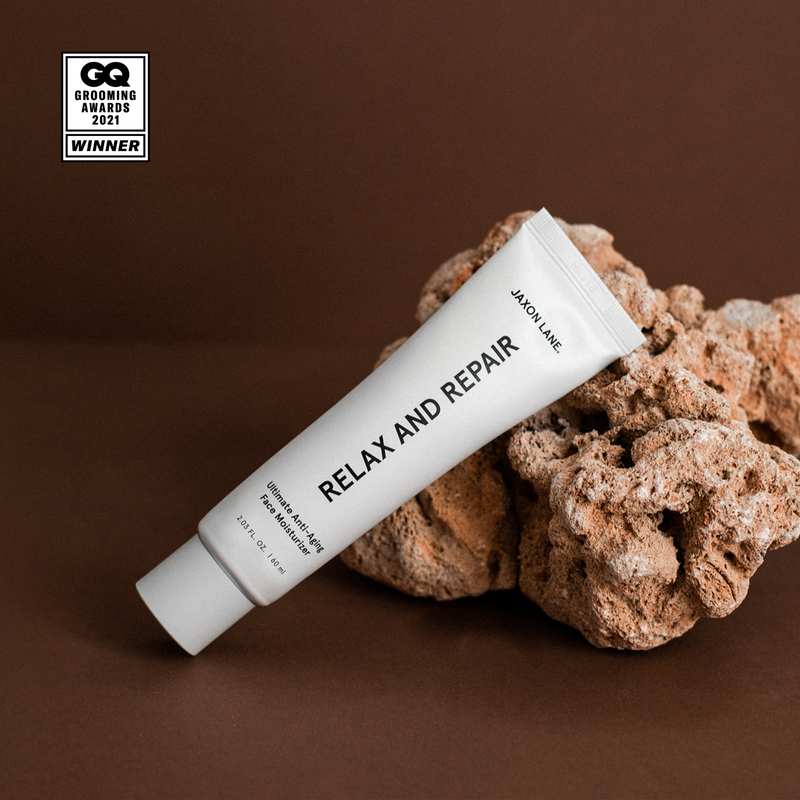 Tube of 'Relax and Repair' cream on a brown background with GQ Grocerio Awards 2021 winner badge.