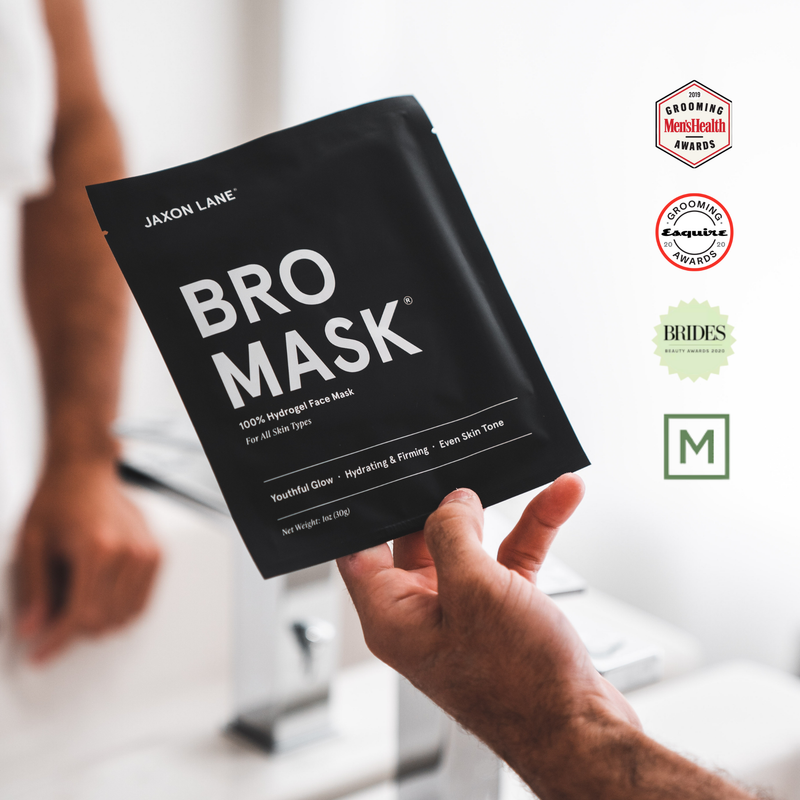 Person holding a Jaxon Lane Bro Mask packaging with certification logos in the corner awards