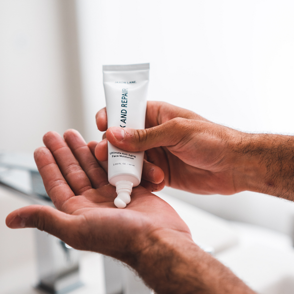 Hand holding a tube of 'Relax and Repair' cream against a blurred indoor background