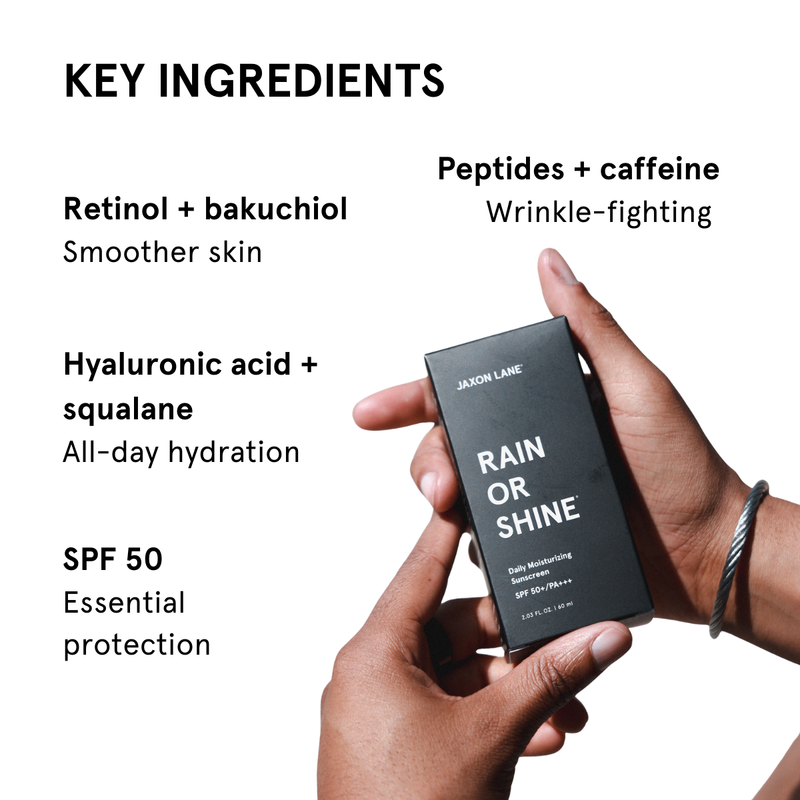 Hand holding a skincare product packaging with key ingredients listed on a white background